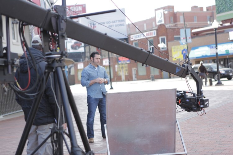 Host David Guas takes a moment during a break in shooting for the Travel Channel’s “American Grilled.”