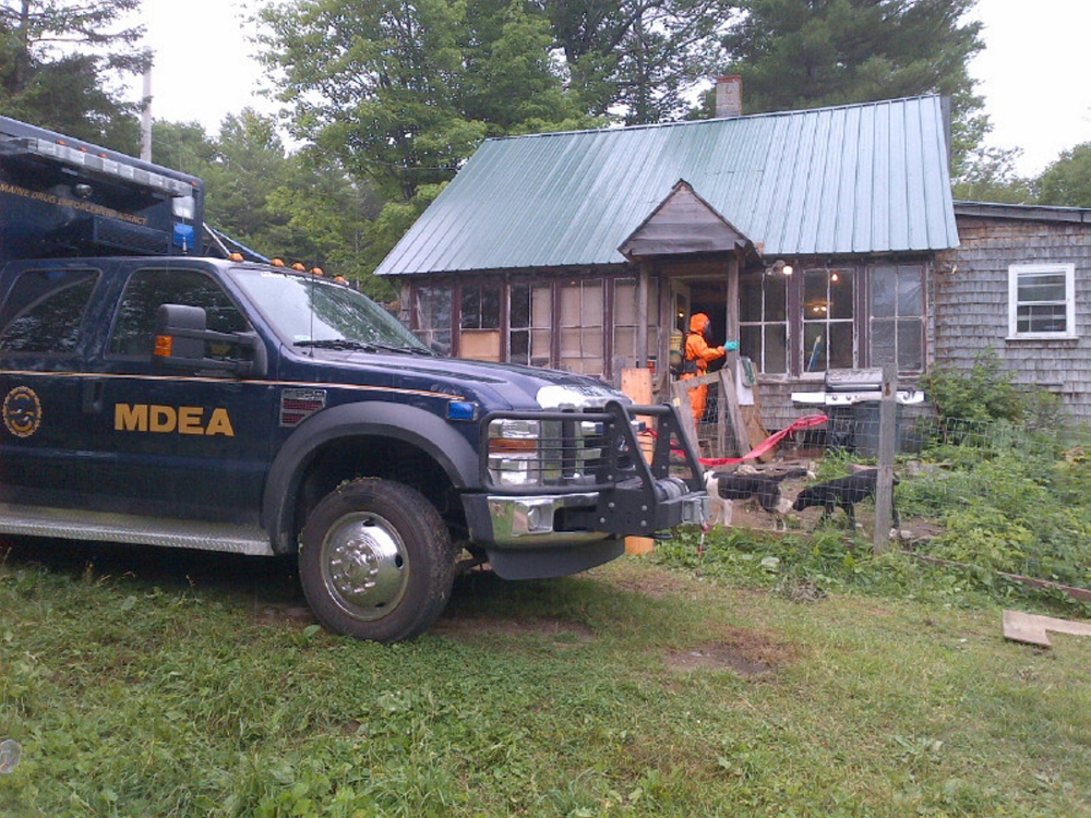 Members of the Maine Drug Enforcement Agency and Maine Department of Environmental Protection dismantle a suspected meth lab in Phillips on Tuesday.