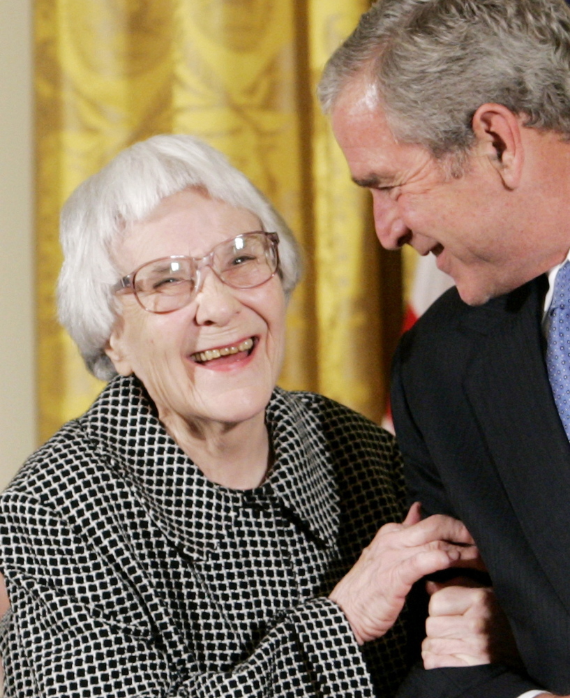 Former President George W. Bush, right, smiles before awarding the Presidential Medal of Freedom to American novelist Harper Lee in the East Room of the White House, on November 5, 2007.