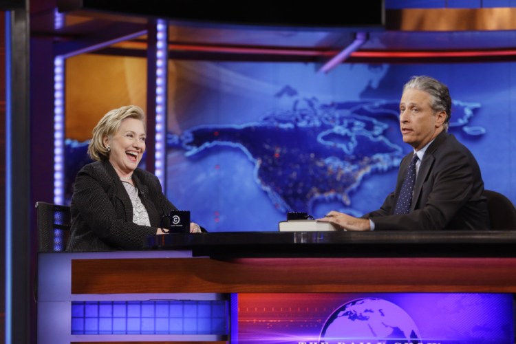 Former U.S. Secretary of State Hillary Rodham Clinton reacts to host Jon Stewart during a taping of “The Daily Show with Jon Stewart,” Tuesday in New York