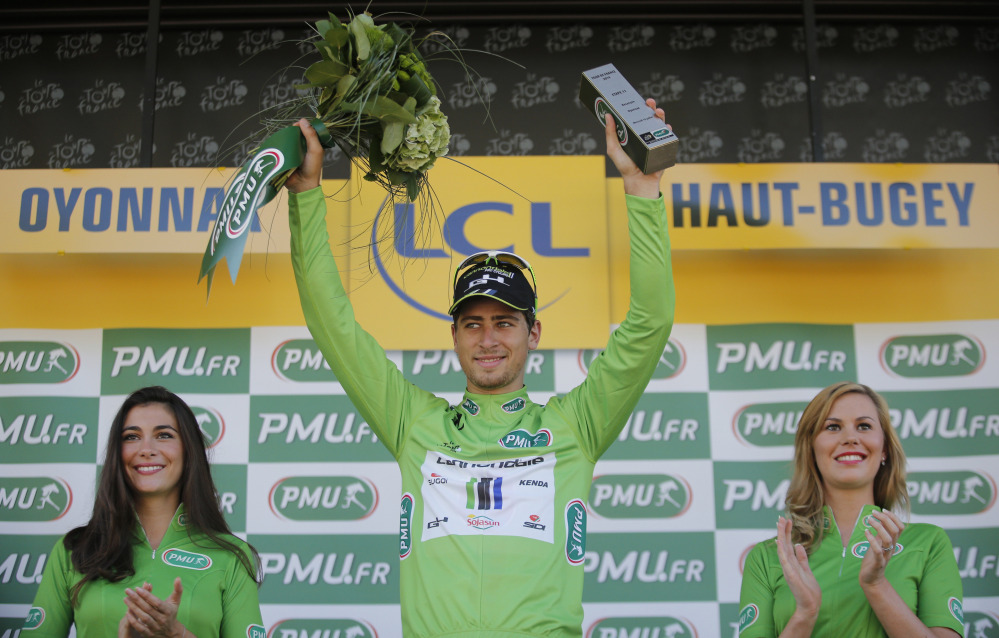 Peter Sagan of Slovakia, wearing the best sprinter’s green jersey, celebrates on the podium of the eleventh stage of the Tour de France cycling race over 187.5 kilometers (116.5 miles) with start in Besancon and finish in Oyonnax, France, Wednesday.