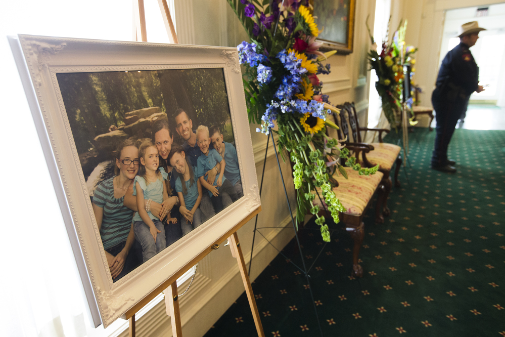 A family portrait of the Stephen and Katie Stay family is on display before visitation at Klein Funeral Home on Tuesday in Houston.