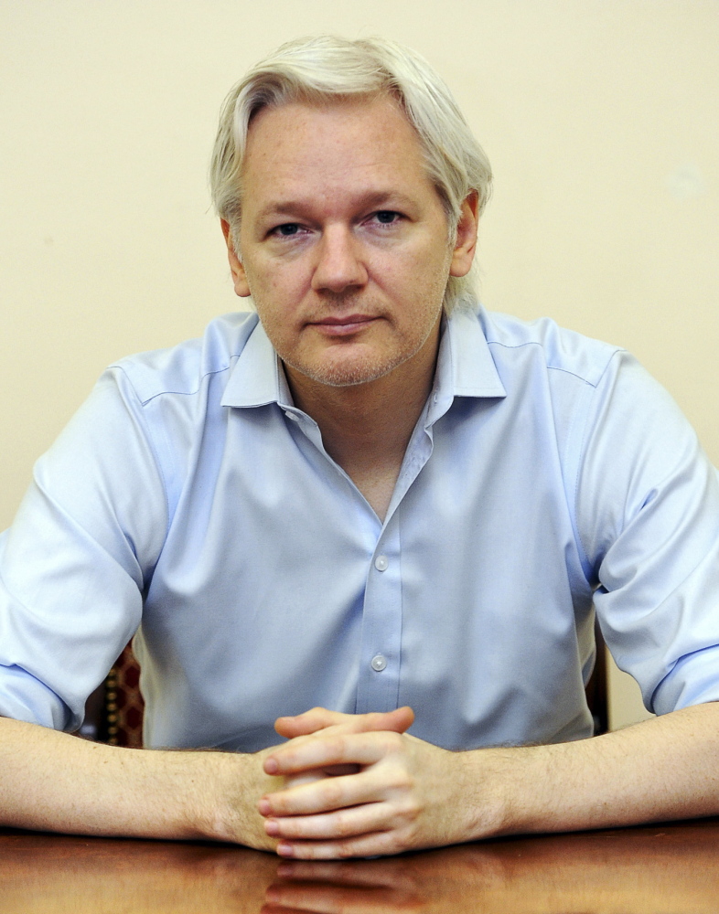 WikiLeaks founder Julian Assange speaks to the media inside the Ecuadorean embassy in London in June.