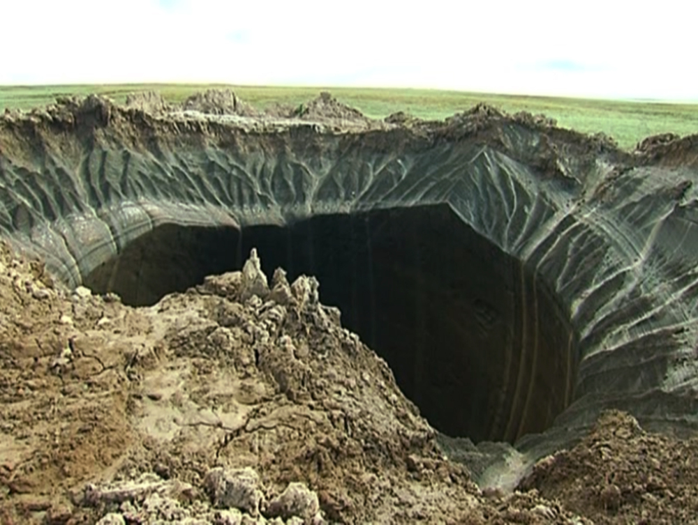 This frame grab made Wednesday, July 16, 2014, shows a crater, discovered recently in the Yamal Peninsula, in Yamalo-Nenets Autonomous Okrug, Russia.