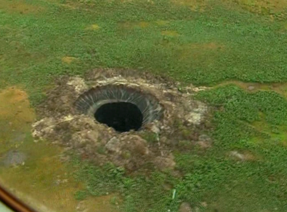 This frame grab made Wednesday, July 16, 2014, shows another view of the crater recently discovered in the Yamal Peninsula, in Yamalo-Nenets Autonomous Okrug, Russia.