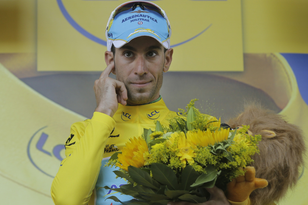 Italy’s Vincenzo Nibali, wearing the overall leader’s yellow jersey, celebrates Thursday after the 12th stage of the Tour de France. He says he expects to be questioned about performance enhancers but the sport has changed.