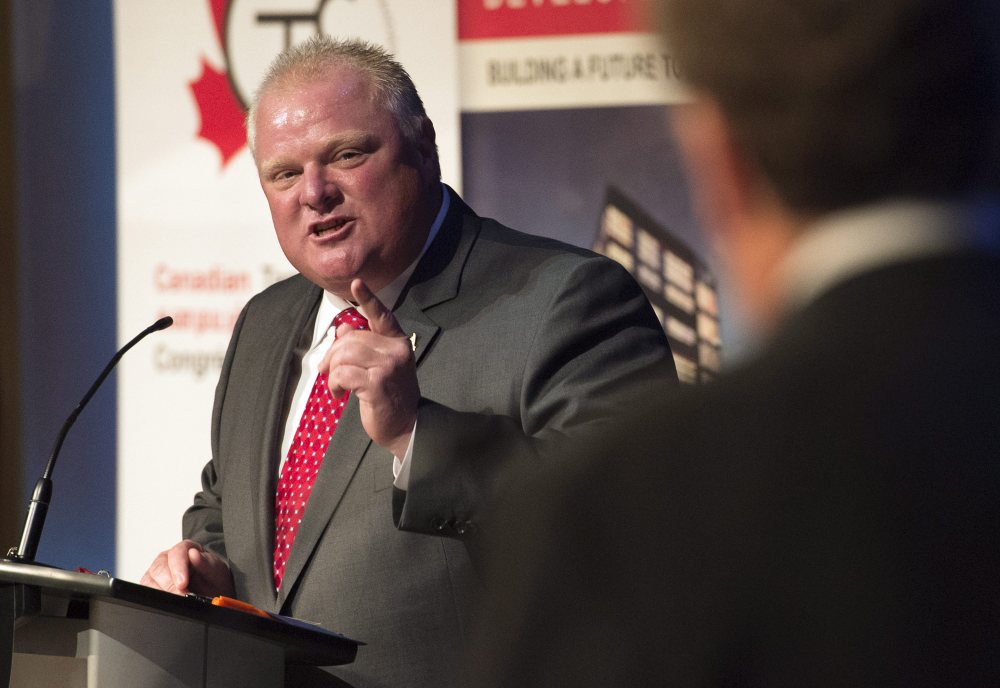 Toronto Mayor Rob Ford makes a point to fellow candidate John Tory during a mayoral debate in Toronto on Tuesday. Ford was both cheered and jeered as he took part in his first mayoral debate since returning to office after a two-month stint in rehab. The Associated Press/The Canadian Press, Darren Calabrese