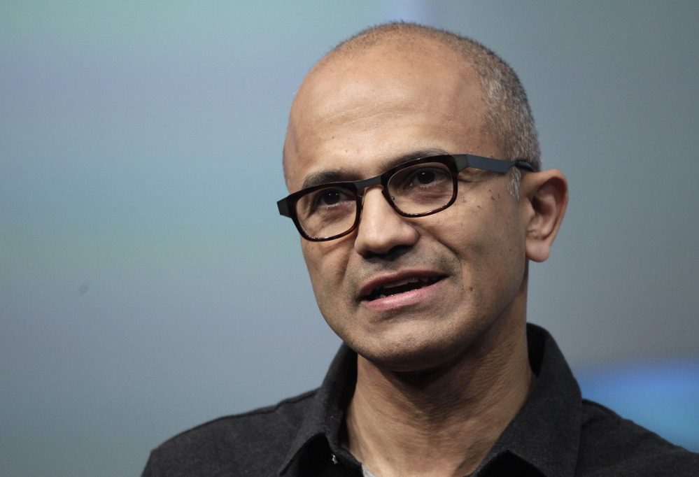 Microsoft CEO Satya Nadella talks during the introduction the Surface Pro 3 tablet device at a media preview in New York in May. Microsoft on Thursday announced it will lay off up to 18,000 workers over the next year.