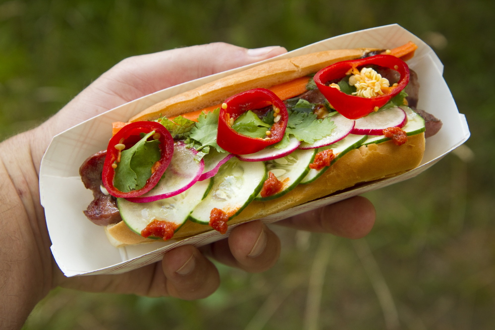 The Hot Dog Indochine features pickled carrot, radish, cilantro, basil, fresno chili, cucumber, citrus chili, mayo and hoisin.