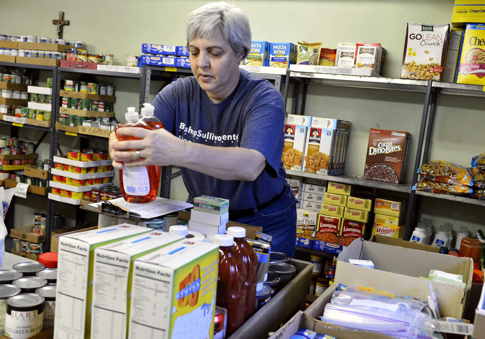 Colleen Simon, seen in April working as the food pantry coordinator for the Diocese of Kansas City-St. Joseph in Kansas City, Mo., was later fired over her same-sex marriage.