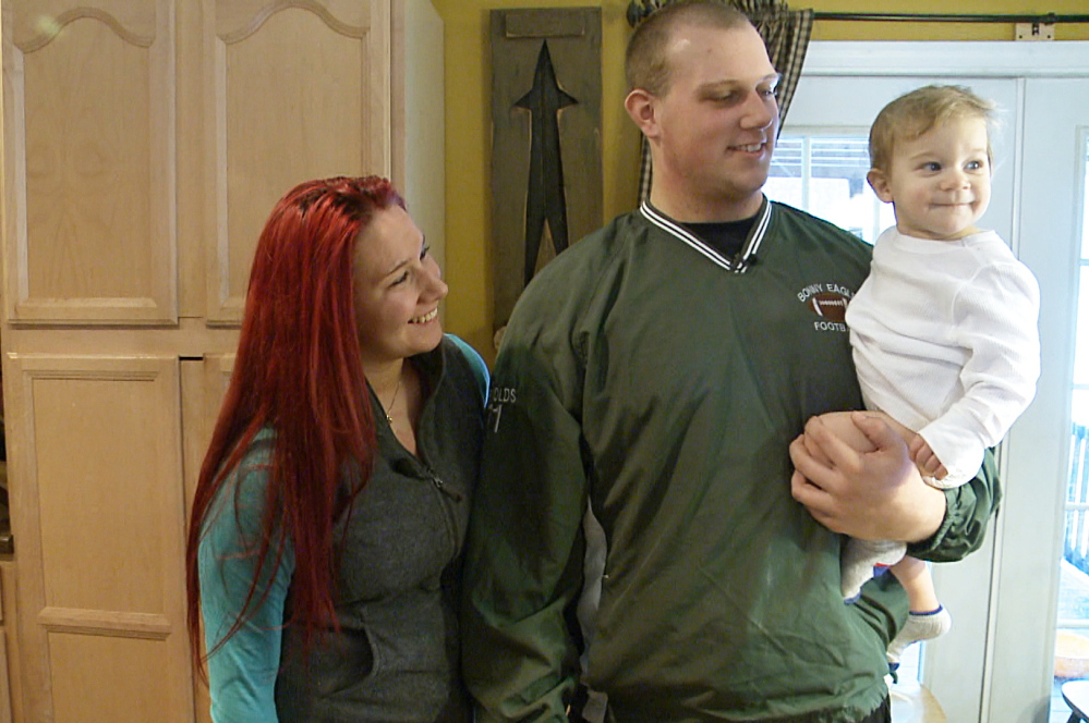 Isaiah Reynolds holds his son, Brody, while standing with his girlfriend, Rachael Tarbox, in a frame grab of a video taken by WCSH in January.