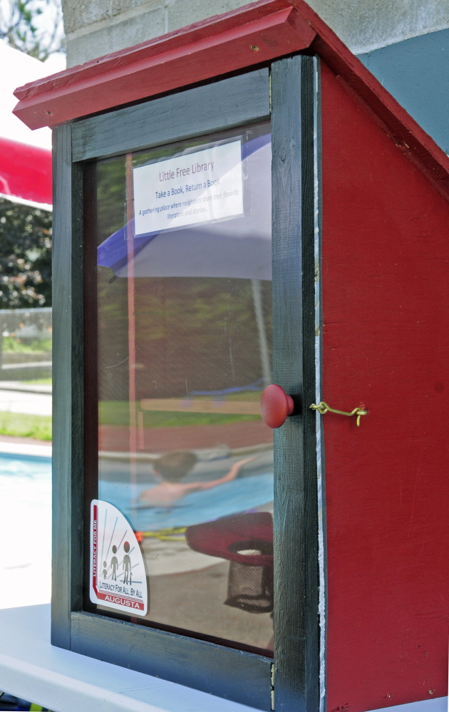 The Little Free Library at the Williams Playground pool in Augusta is one of four small book repositories created to encourage reading by youngsters.