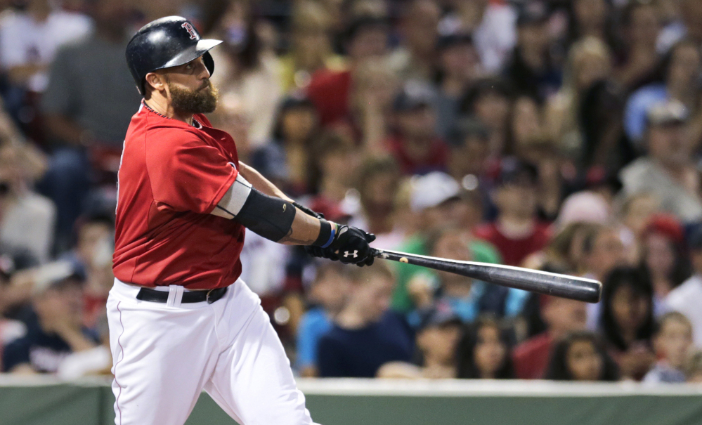 Jonny Gomes hits a two-run home run in the sixth inning to lift the Boston Red Sox to a 5-4 win over the Kansas City Royals on Friday at Fenway Park in Boston. The Associated Press