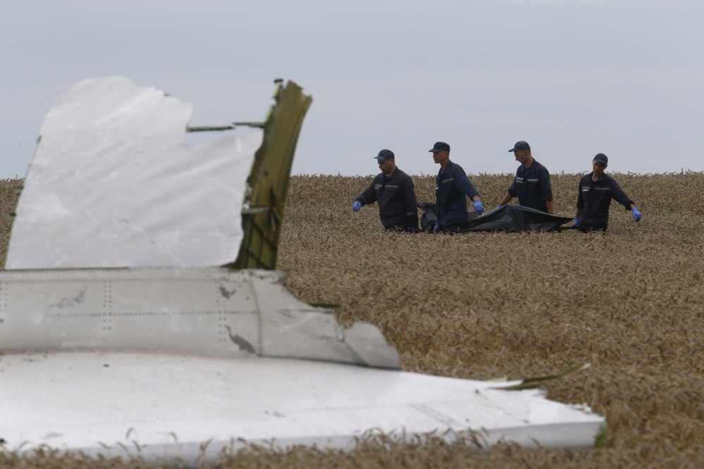 Members of the Ukrainian Emergency Ministry carry a body at the crash site of Malaysia Airlines Flight MH17, near Grabovo in the Donetsk region of Ukraine on Saturday.