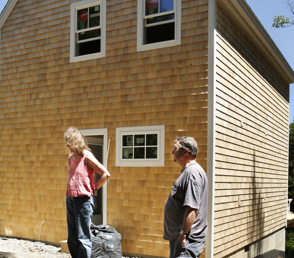Sally and David Wylie of Vinalhaven are building an addition to their home with sound-deadening walls to escape the “whomp, whomp, whomp” generated by turbines at the Fox Islands Wind Project.