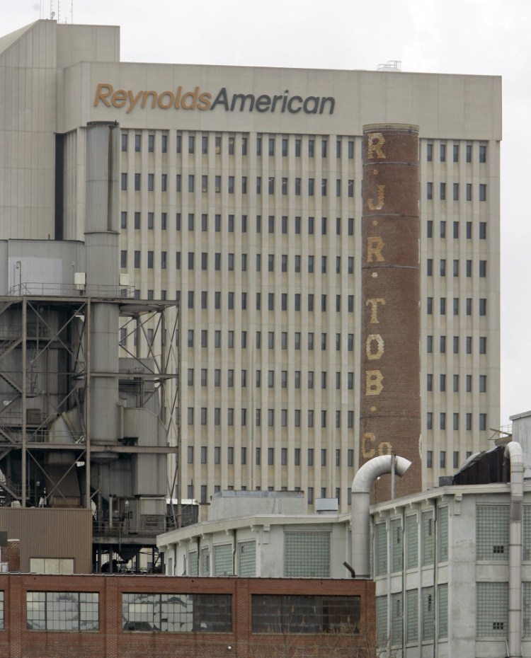 A smokestack of an old R.J. Reynolds Tobacco plant frames the Reynolds American building in Winston-Salem, N.C., in 2008. A Florida jury has slammed R.J. Reynolds Tobacco Co. with $23.6 billion in punitive damages in a lawsuit filed by Cynthia Robinson, the widow of a longtime smoker who died of lung cancer in 1996.