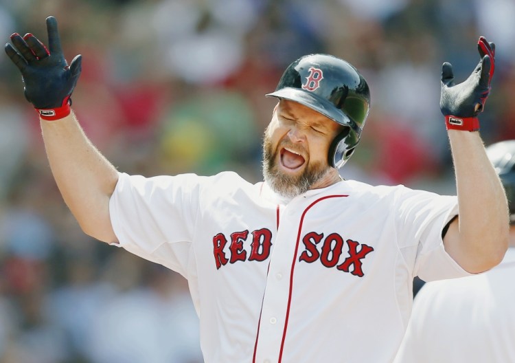 Red Sox catcher David Ross celebrates his two-run home run in the fourth inning against the Kansas City Royals in Boston on Sunday.