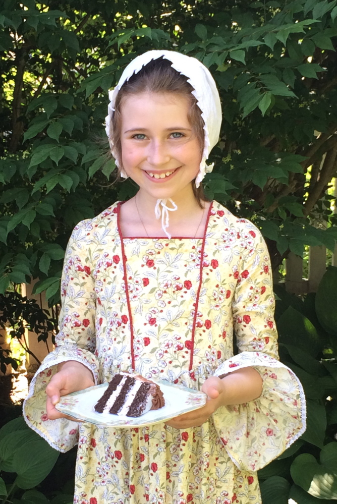 Junior docent Elizabeth Akin dresses in period costume and serves cake for an event at the Gen. Henry Knox Museum in Thomaston. The museum invites the public to attend its annual “Cut the Cake!” event Saturday, celebrating the birthday of namesake Henry Knox.