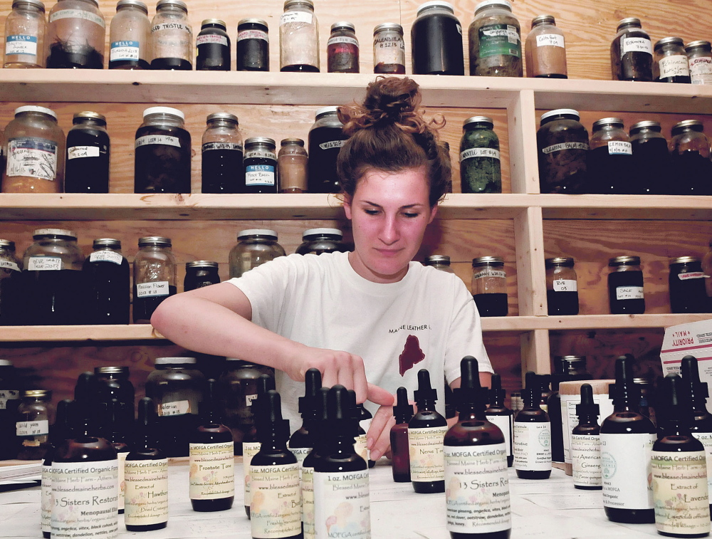 Belle Hilmer creates tinctures made with ingredients grown at Blessed Maine Herb Farm in Athens. She is a daughter of the farm’s founder, Gail Faith Edwards.