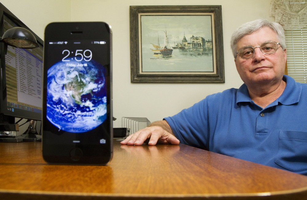 Don Day of Scarborough sits at his desk in his home office. He says poor cellphone coverage is a safety issue and could lower property values because young home buyers lack landlines and need reliable coverage. Carl D. Walsh/Staff Photographer