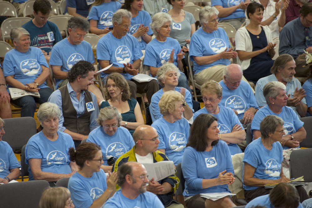 Citizens in favor of the ban to keep tar sand oil from entering the harbor in South Portland wear blue shirts  during the South Portland City Council meeting Monday. 
Logan Werlinger/Staff Photographer