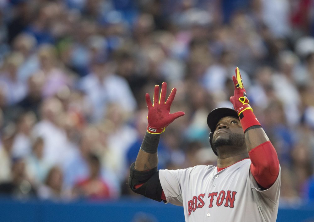 Boston Red Sox’s David Ortiz celebrates his two-run home run in the fourth inning against the  Blue Jays in Toronto on Monday.