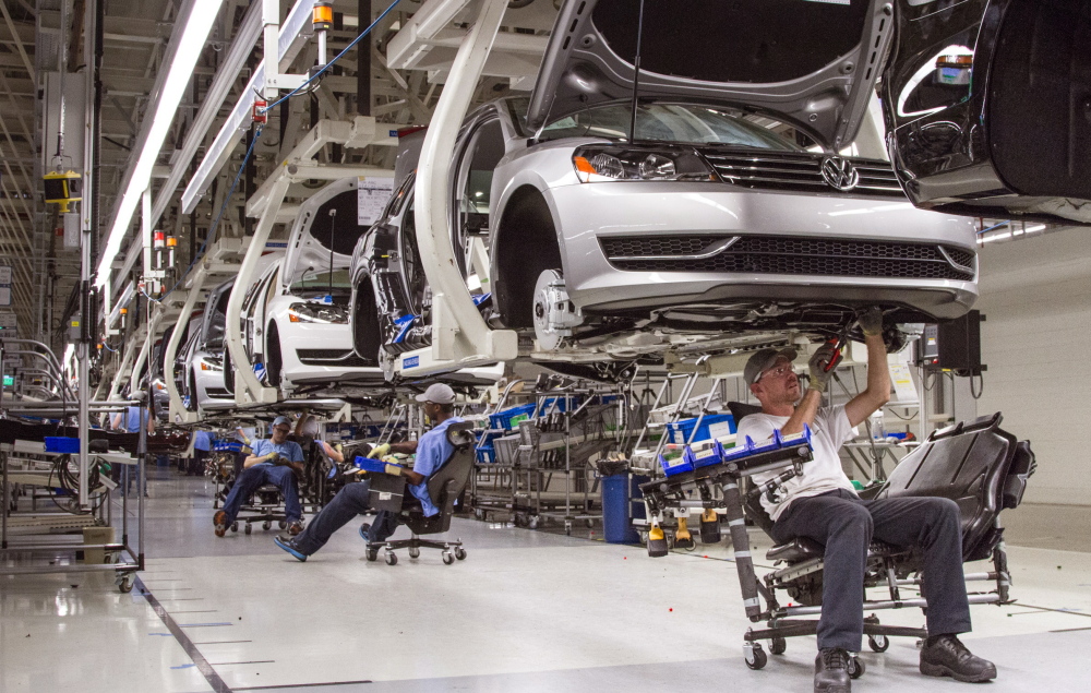 Employees at a Volkswagen plant in Tennessee assemble Passat sedans. Automakers including Volkswagen and GM are enticing Americans with ads promising cheap leases.