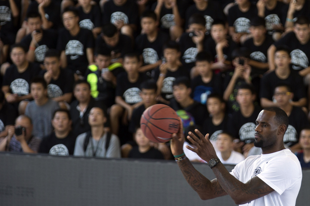 NBA basketball star LeBron James catches a basketball during a Nike-sponsored event in Beijing, China, Monday.