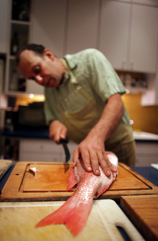 Paul Greenberg, here filleting a red snapper, wants Americans to use more whole fish.