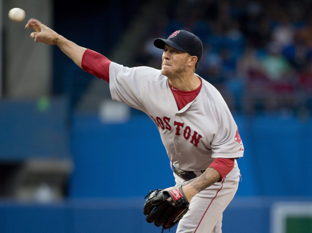 Boston Red Sox starting pitcher Jake Peavy works against the Toronto Blue Jays during the first inning of Tuesday’s game in Toronto.