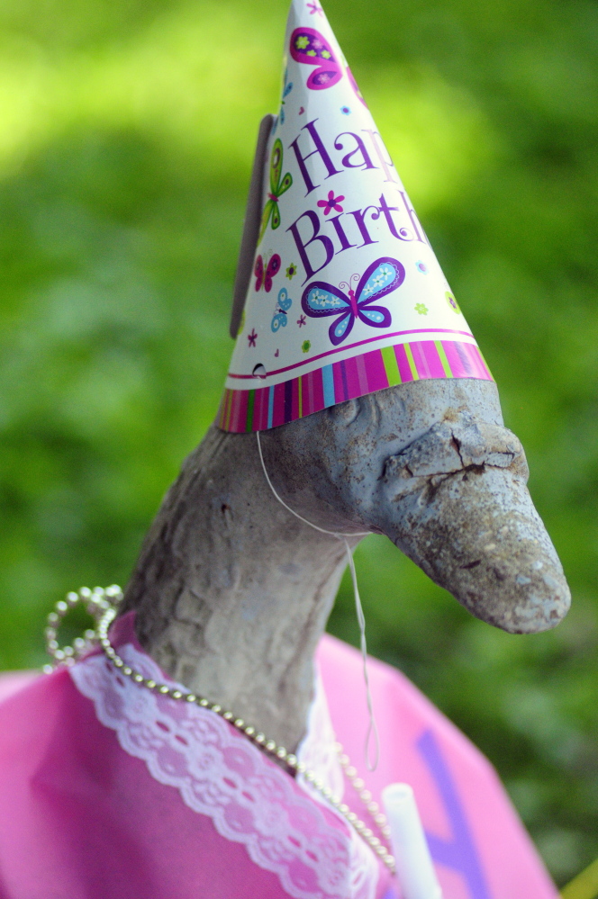 Staff photo by Joe Phelan
Georgie the concrete goose statue is seen wearing birthday attire in the photo taken on Wednesday in front of Marjorie Scott’s Eastern Avenue home in Augusta. She has been dressing it up for 20 years.