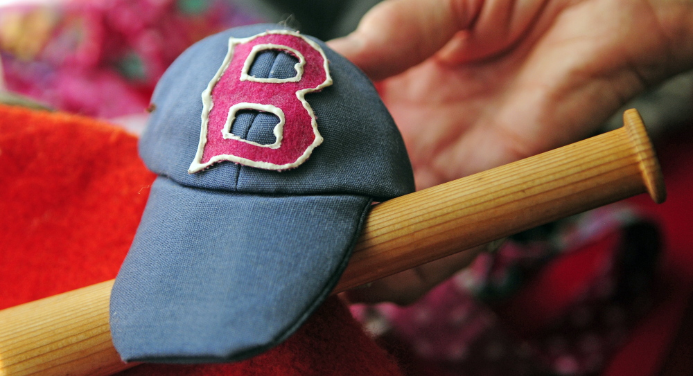 Marjorie Scott has over 100 outfits for Georgie the concrete goose, like these Red Sox accessories photographed on Wednesday in Augusta. She has been dressing it up for 20 years.