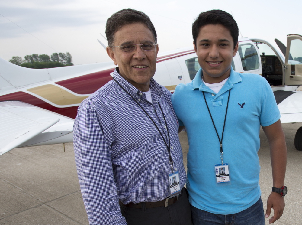 Babar Suleman and son Haris Suleman, 17, stand next to their plane June 19 at an airport in Greenwood, Ind.