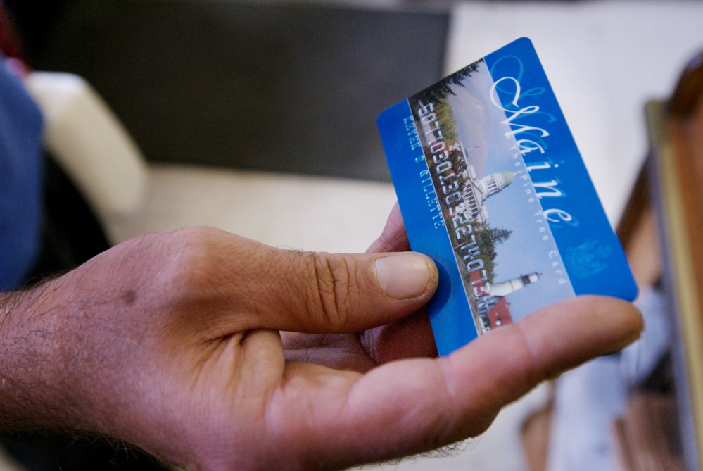 A Portland man uses a magnetic food stamp card to pay for his groceries in 2008. Gov. Paul LePage is proposing a ban on food stamps for anyone convicted of a drug felony in the past two decades.