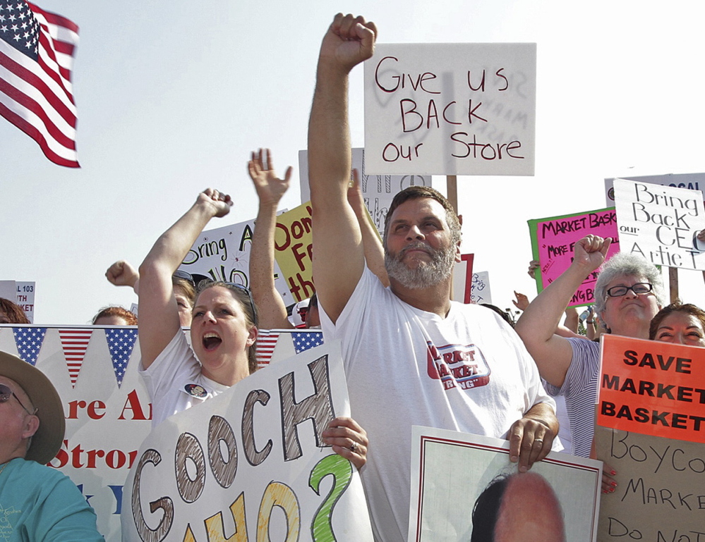 Market Basket employees and supporters rally Friday in Tewksbury, Mass., in support of ousted CEO Arthur T. Demoulas. Instability at Market Basket has been a boon to other grocery stores.