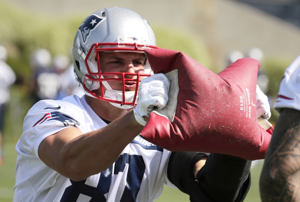New England Patriots tight end Rob Gronkowski works out with a weighted bag during training camp in Foxborough, Mass. The Associated Press