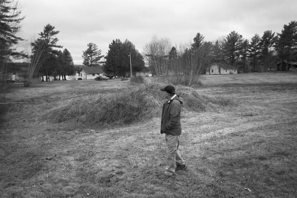 Passamaquoddy historian Donald Soctomah walks past a weed-covered gravel pile just off Route 1 in Indian Township, where a handful of Indians sat in protest 50 years ago, stopping a white man from building a road on reservation land, and starting a chain of events that would alter the course of history.