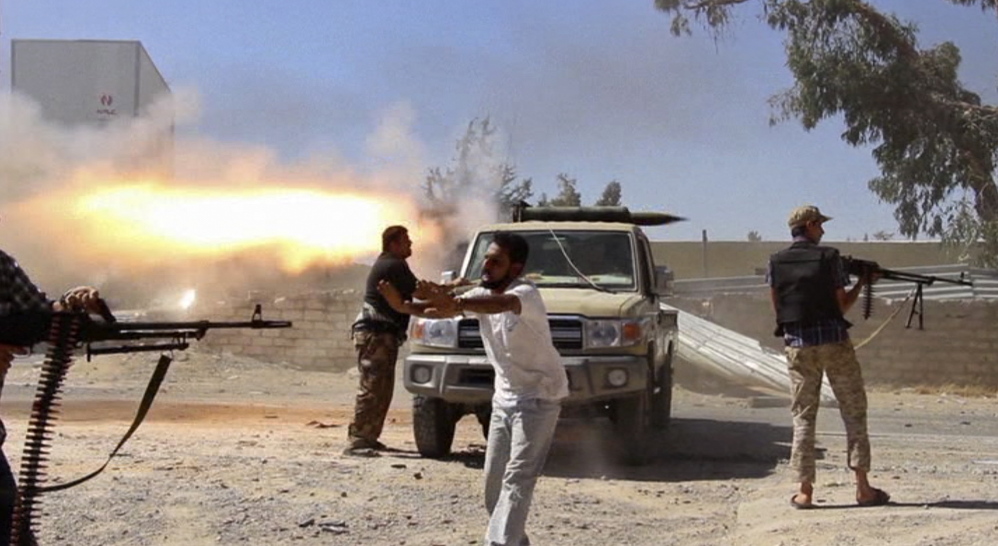 In this frame grab from a freelance journalist’s video, fighters from the Islamist Misarata brigade fire toward the Tripoli airport Saturday in an attempt to wrest control from a rival militia. The battle for the airport has killed 79 and wounded 400.