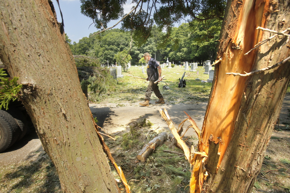 Doug Briley of Chase Tree Service cleans up debris Wednesday in the First Parish Cemetery in York after a microburst hit the York Village area July 15. In 2010, a microburst hit the same part of town, causing in $100,000 in damage.