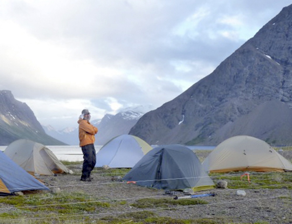 A fellow hiker took this photo of Matt Dyer at the campsite in Canada before he was attacked by a polar bear after dark in July 2013. Dyer’s group used an electrified fence, in foreground, at the site to try to prevent bear attacks, but the bear broke through it. Dyer now believes it’s inadequate to sleep behind an electrified bear fence.