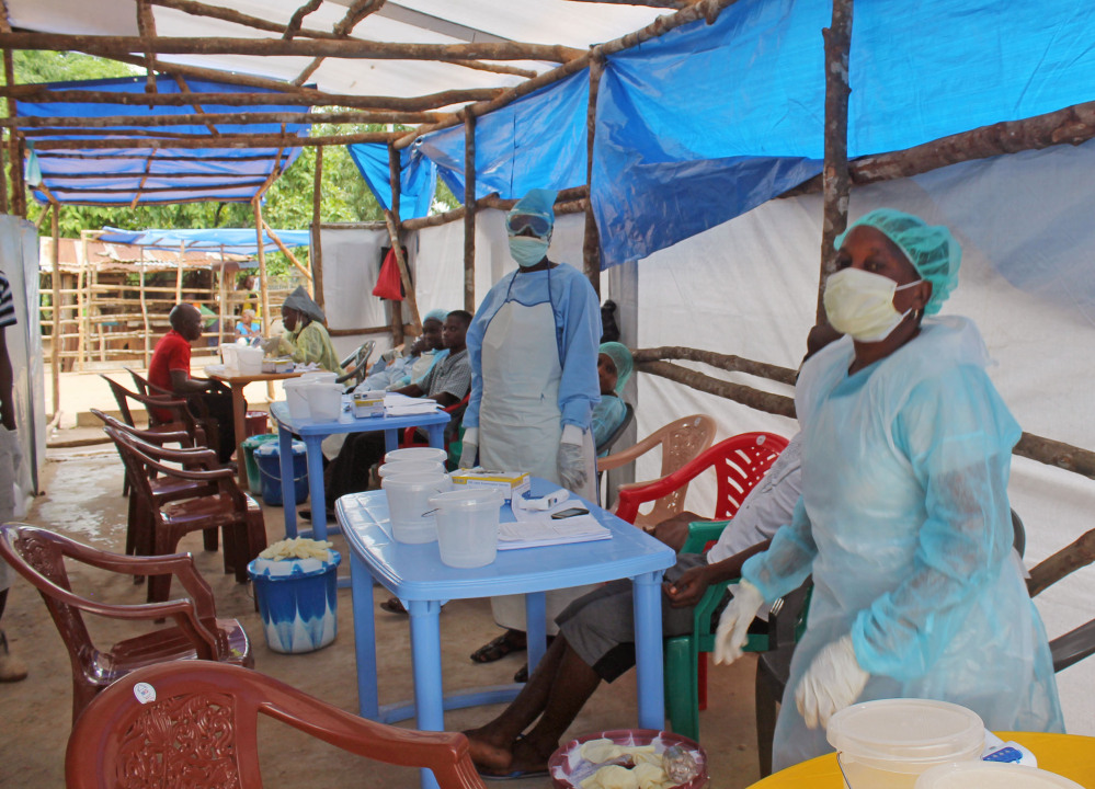 In this photo taken on Sunday, July 27, 2014, medical personnel inside a clinic take care of Ebola patients in the Kenema District on the outskirts of Kenema, Sierra Leone. Liberia President Ellen Johnson Sirleaf has closed some border crossings and ordered strict quarantines of communities affected by the Ebola outbreak.