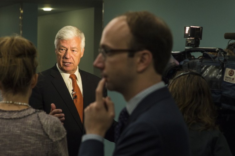 U.S. Rep. Mike Michaud, Maine's Democratic candidate for governor, answers questions from reporters before the Democratic National Committee rally on Monday.