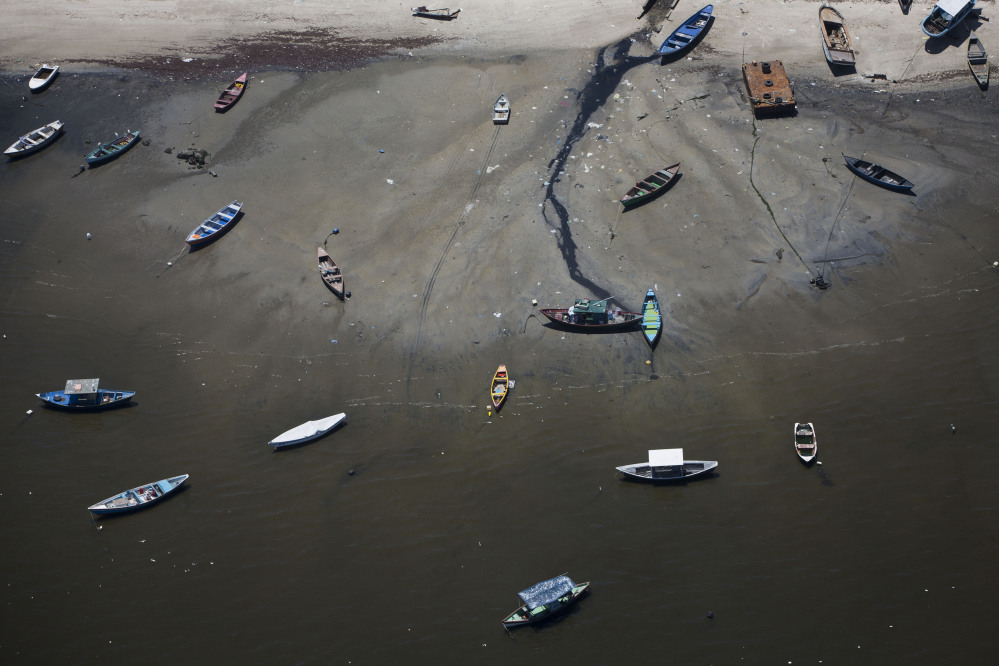 In this Nov. 19, 2013 photo small boats sit on the shore of Guanabara Bay in the suburb of Sao Goncalo, across the bay from Rio de Janeiro, Brazil.