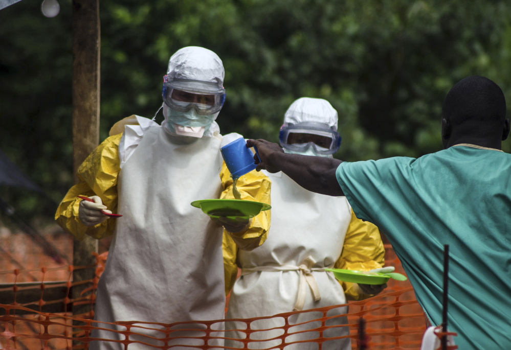 Medical staff working with Doctors Without Borders prepare to bring food to patients kept in an isolation area at an Ebola treatment center in Sierra Leone on July 20. Sierra Leone has 454 cases of Ebola, the most in the world.
