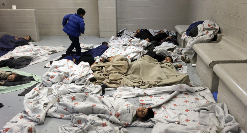 Detainees sleep in a holding cell at a U.S. Customs and Border Protection processing facility in Brownsville, Texas. A new Associated Press-GfK poll finds two-thirds of Americans now say illegal immigration is a serious problem.