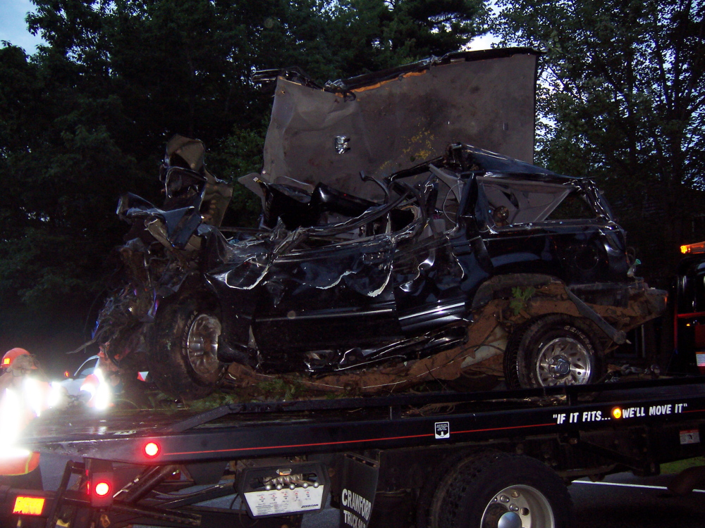 A wrecker takes away the car that crashed early Wednesday morning.