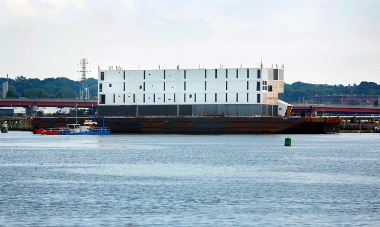Google's barge, carrying a still-mysterious four-story structure, was hauled by tugboat from Portland to South Portland on Wednesday to be prepared for an “ocean voyage.” 