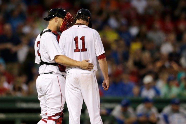 Red Sox starting pitcher Clay Buchholz  talks with catcher David Ross before giving up a two-run single to the Blue Jays' Ryan Goins during the fourth inning of a game at Fenway Monday. The Associated Press
