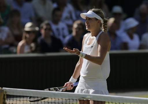 Eugenie Bouchard of Canada disputes a line call with the umpire as she plays against Simona Halep of Romania during their women's singles semifinal match at the All England Lawn Tennis Championships in Wimbledon, London, on Thursday. The Associated Press