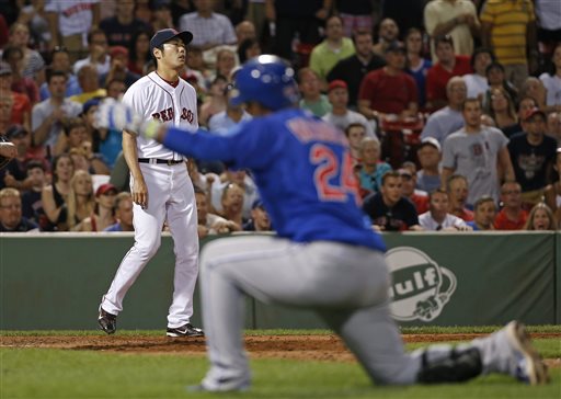 Red Sox relief pitcher Koji Uehara reacts after giving up an RBI sacrifice fly to the Cubs' Luis Valbuena, who kneels to watch teammate Anthony Rizzo score in the ninth inning at Fenway Park on Tuesday. The Associated Press